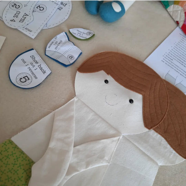 Henry Doll sewing project in progress with felt hair and printed pattern pieces