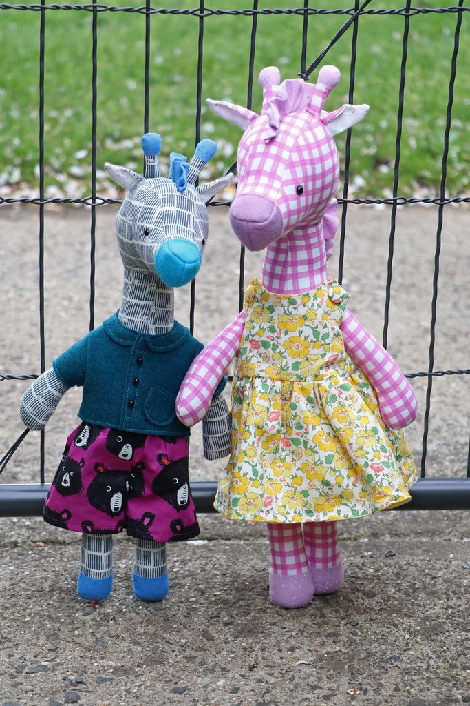 Two giraffe plush toys in handmade clothing from PDF sewing pattern