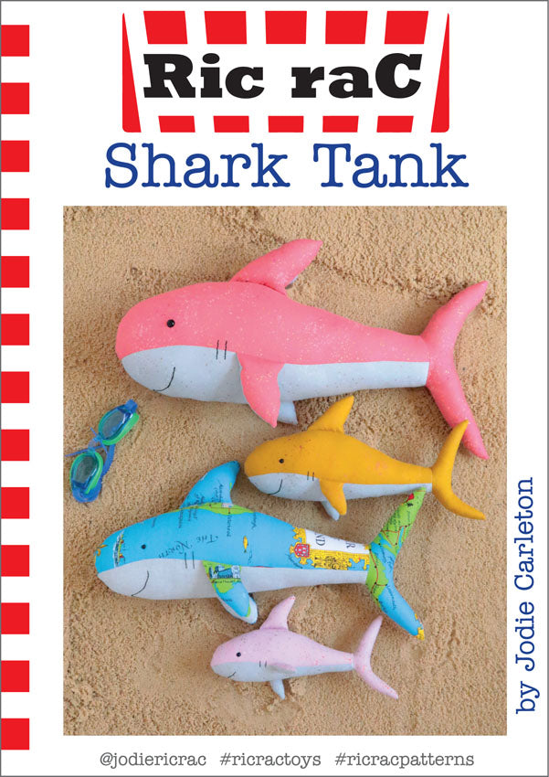 Cover of 'Ric raC Shark Tank' with colorful shark toys on a sand background