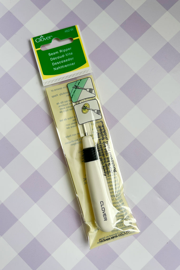 Clover seam ripper in packaging on a checkered background