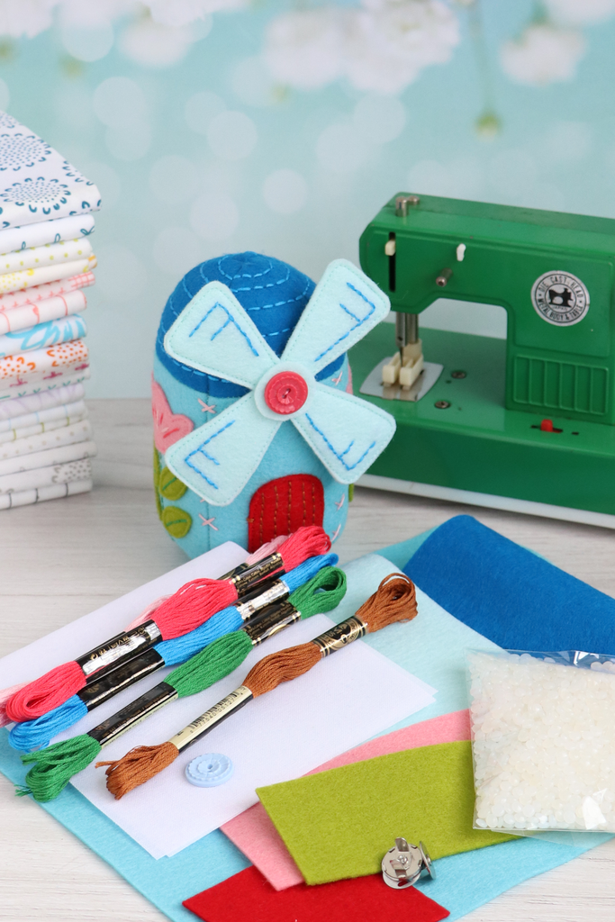 Close-up of felt sheets used in the Windmill pincushion kit, with finished pincushion in background.