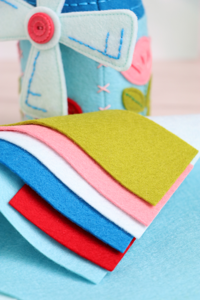 Close-up of felt sheets used in the Windmill pincushion kit, with finished pincushion in background.