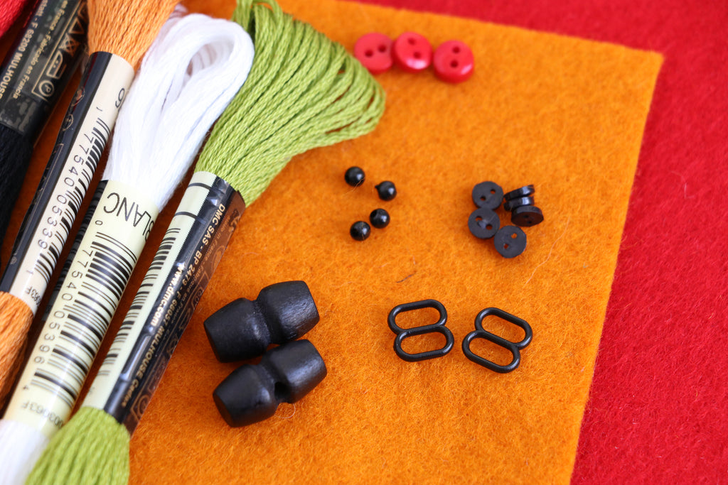 Daryl & Russ sewing kit supplies including felt, threads, and buttons for crafting felt dogs.