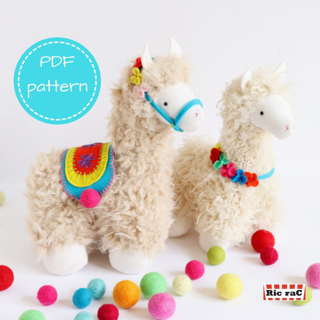 Handmade plush llama toys with curly fur, colorful felt saddle and garland, surrounded by bright felt balls. Soft toy sewing pattern example.