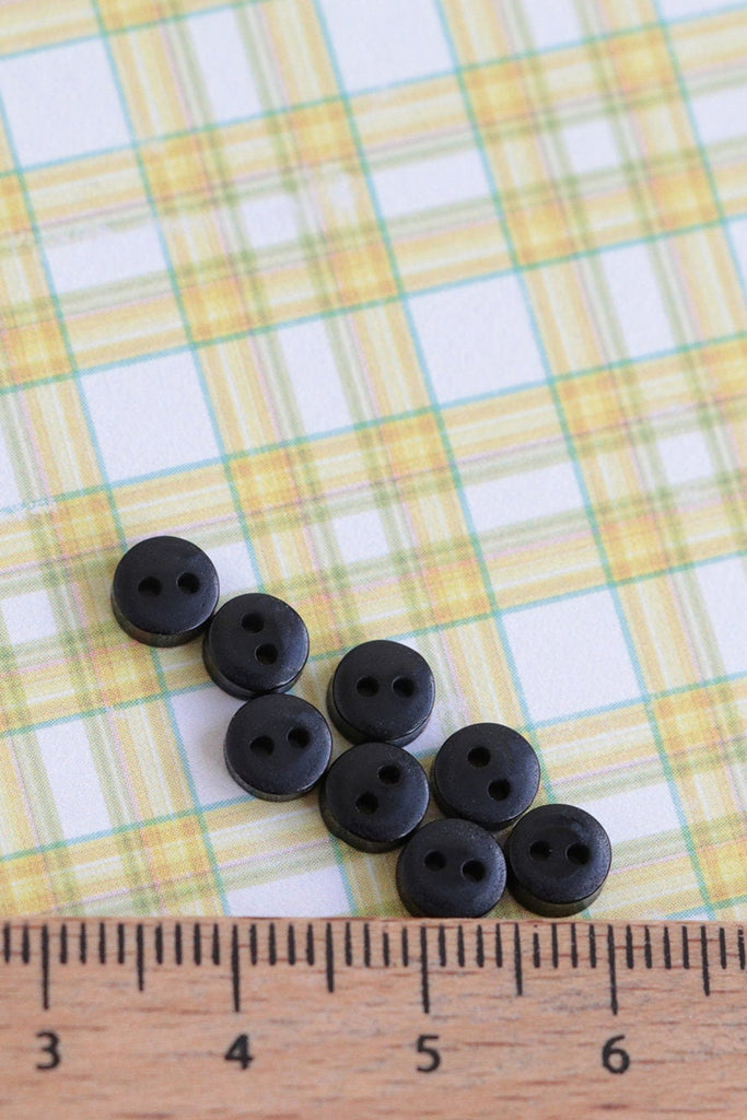 A group of black buttons for toymaking
